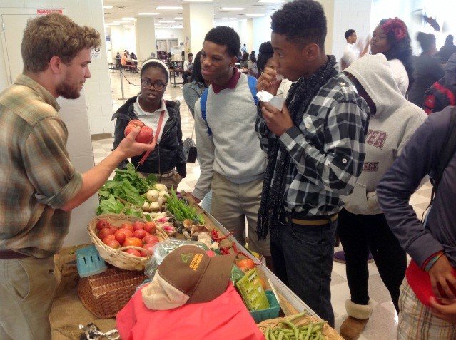 Farmer Christopher Horachek of Cosmos Organic Farm visits with Carver High School students.